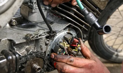 MECHANIC NEAR SILKBOARD DOING WORK ON ENGINE